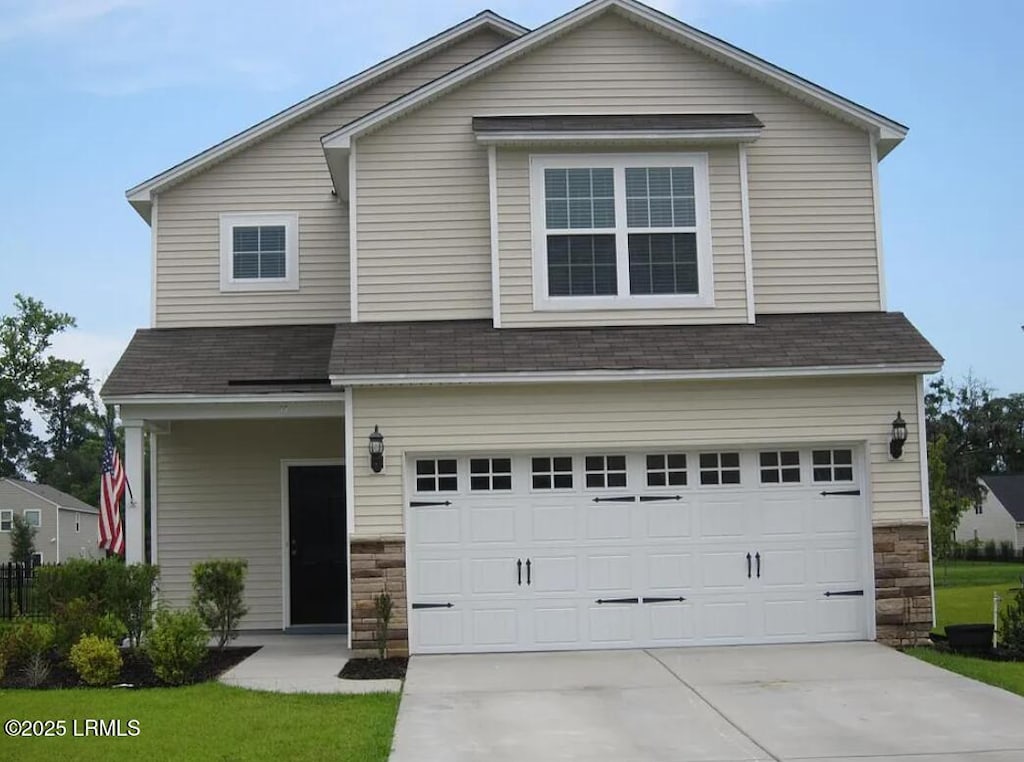 11 Seneca Way, Beaufort, SC 29906 - view of front of home with stone siding, roof with shingles, driveway, and an attached garage