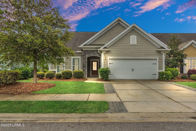 149 Kings Creek Dr, Bluffton, SC 29909 - view of front facade with concrete driveway, a garage, a lawn, and stone siding
