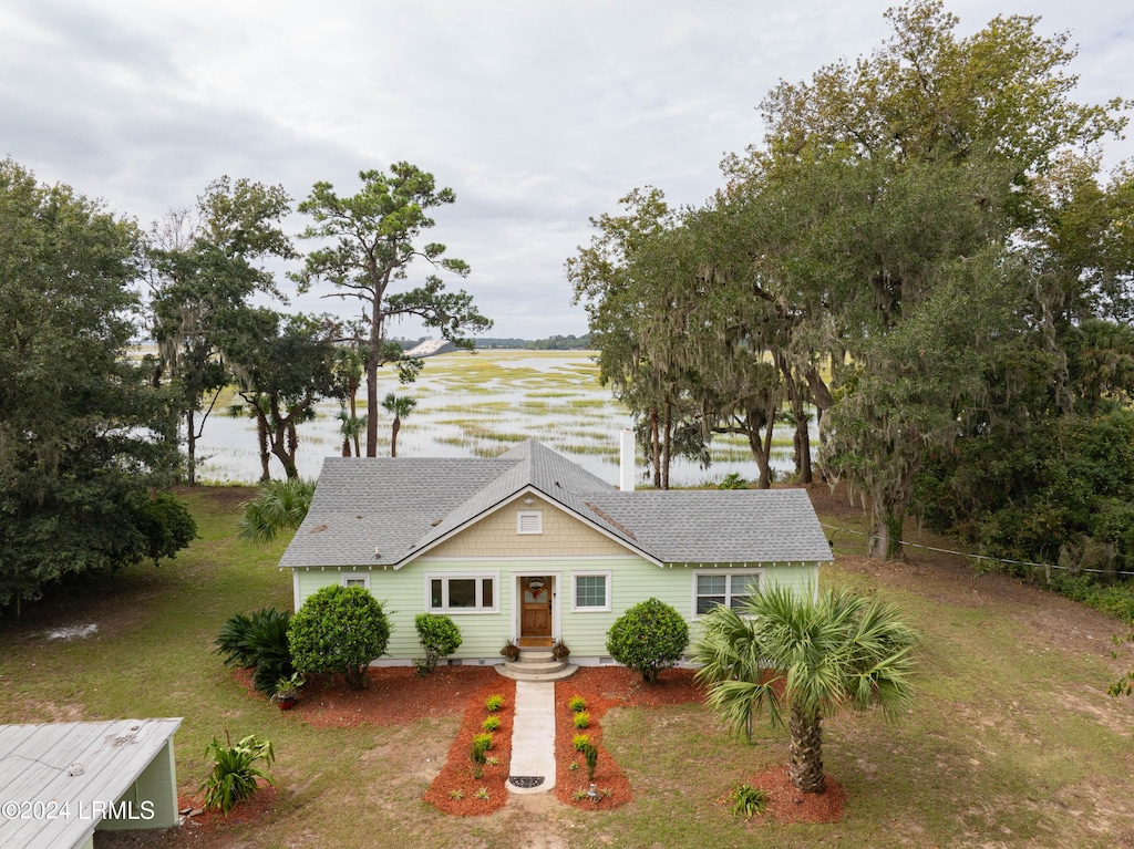 view of front facade with a water view and a front yard