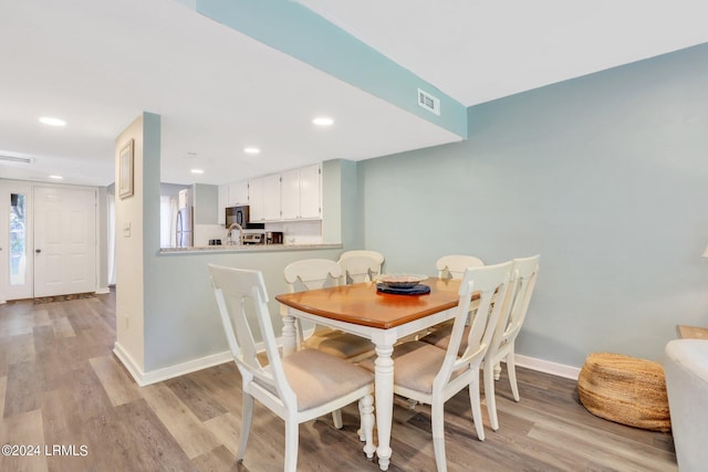 dining area featuring light wood-type flooring