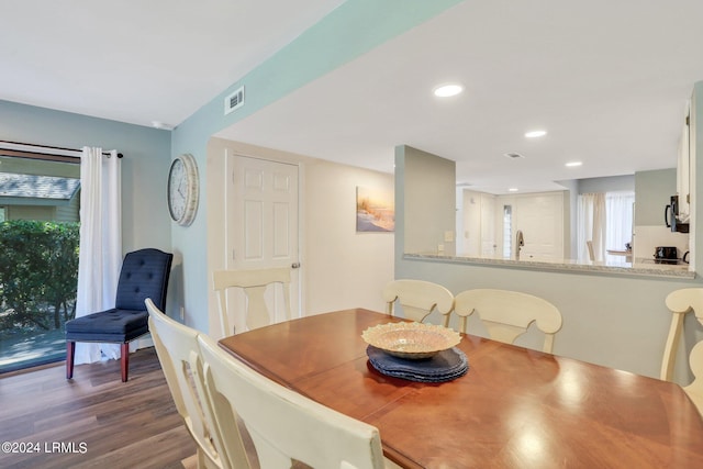 dining area with dark hardwood / wood-style flooring, sink, and a wealth of natural light