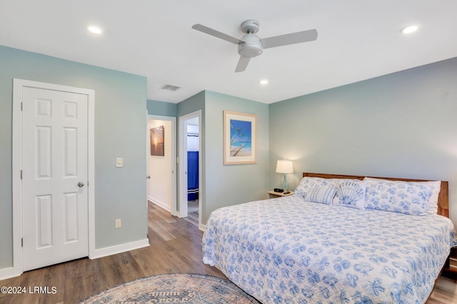 bedroom featuring ceiling fan, connected bathroom, and hardwood / wood-style floors