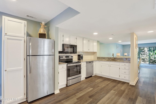 kitchen featuring white cabinetry, appliances with stainless steel finishes, sink, and dark wood-type flooring