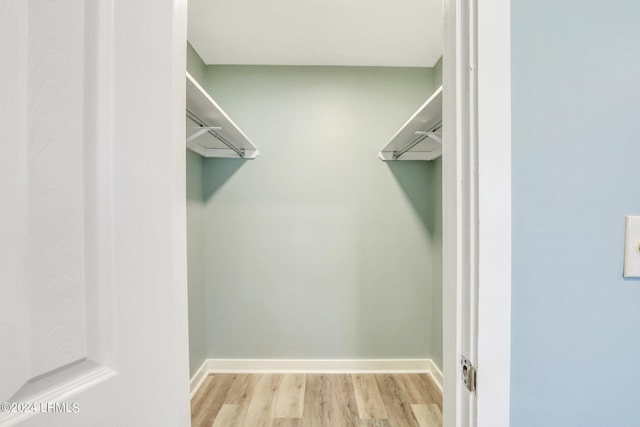 walk in closet featuring light hardwood / wood-style floors