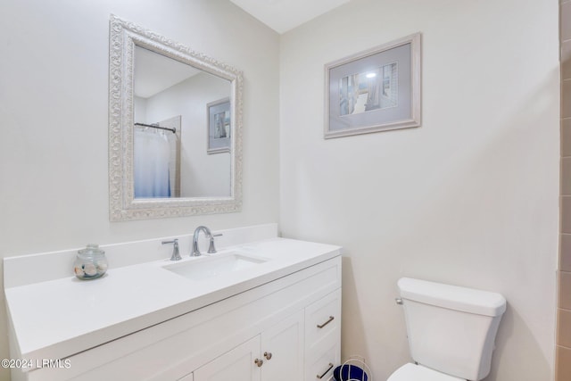 bathroom featuring vanity, a shower with curtain, and toilet