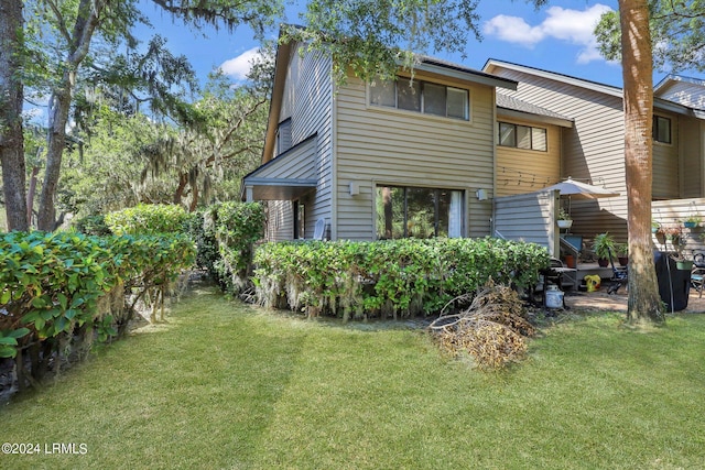 rear view of house with a yard