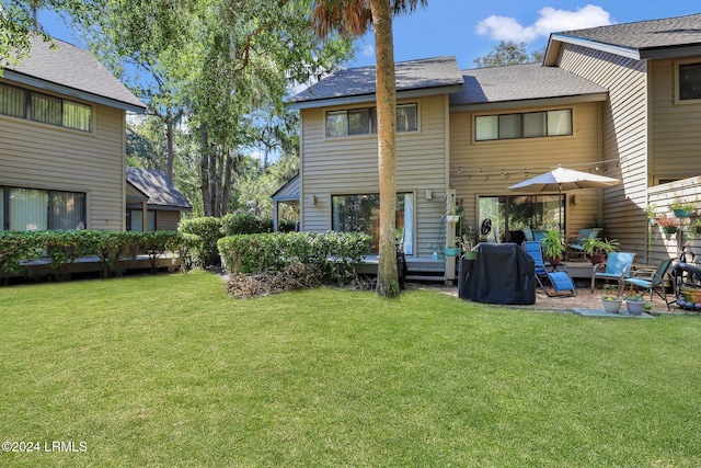 rear view of property featuring an outdoor living space and a yard