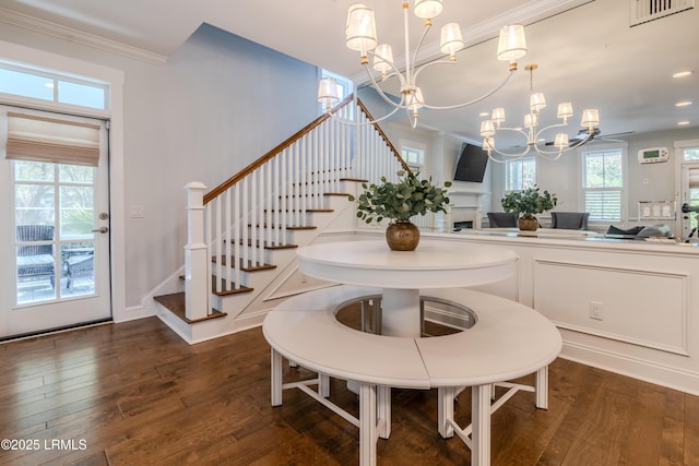 dining area with a chandelier, ornamental molding, dark wood finished floors, and visible vents