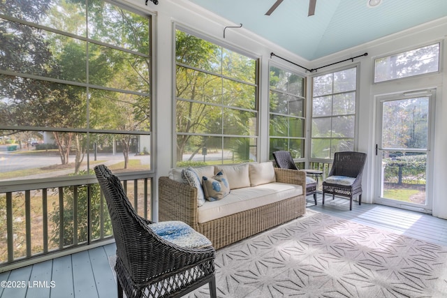 sunroom featuring vaulted ceiling and ceiling fan