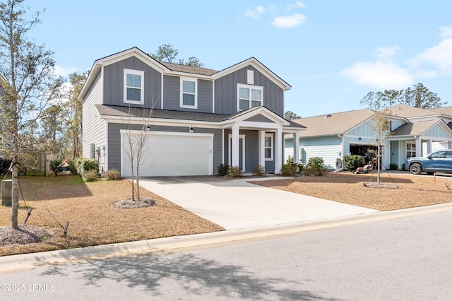 view of front of house with board and batten siding, driveway, and a garage