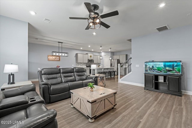 114 Danner Dr, Bluffton, SC 29909 - living area featuring a ceiling fan, light wood-style floors, baseboards, stairway, and recessed lighting