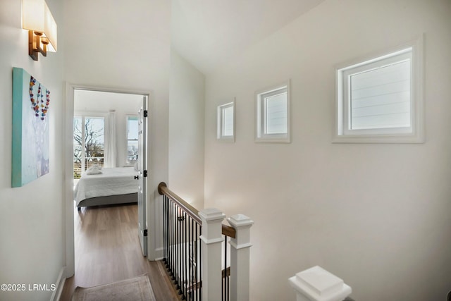 corridor with hardwood / wood-style floors