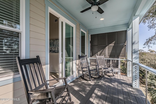 wooden terrace featuring ceiling fan and covered porch