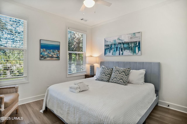 bedroom featuring ornamental molding, dark hardwood / wood-style floors, and ceiling fan