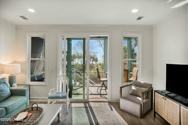 entryway with crown molding and hardwood / wood-style flooring