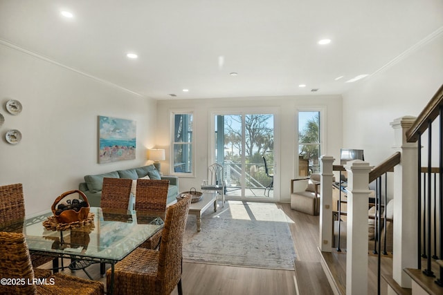 dining space with crown molding and light hardwood / wood-style floors