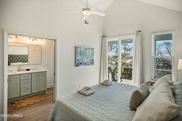 bedroom featuring access to exterior, wood-type flooring, sink, and ceiling fan