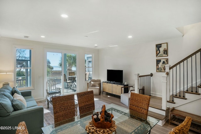 living room featuring ornamental molding and wood-type flooring