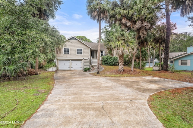 view of front of property with a garage and a front yard