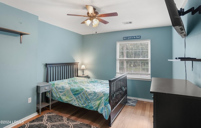 bedroom with hardwood / wood-style flooring and ceiling fan