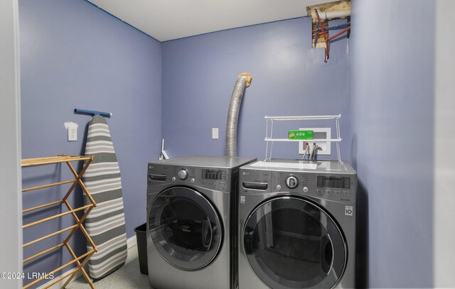 clothes washing area with separate washer and dryer