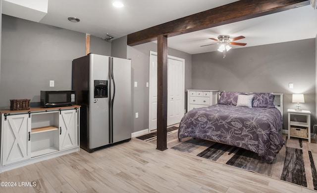 bedroom with ceiling fan, stainless steel fridge, beam ceiling, and light wood-type flooring