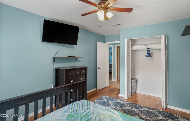 bedroom featuring ceiling fan, a closet, and light wood-type flooring