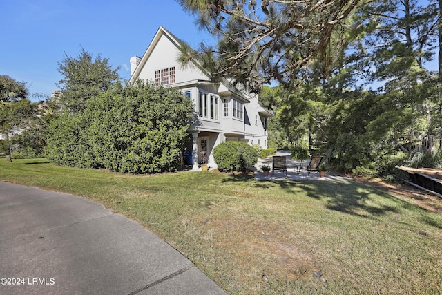 view of home's exterior featuring a yard and a patio area