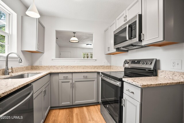 120B Tamara Ln, Port Royal, SC 29935 - kitchen with appliances with stainless steel finishes, gray cabinetry, healthy amount of natural light, and a textured ceiling