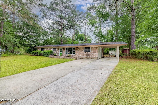 ranch-style house with driveway, a front lawn, a carport, and brick siding