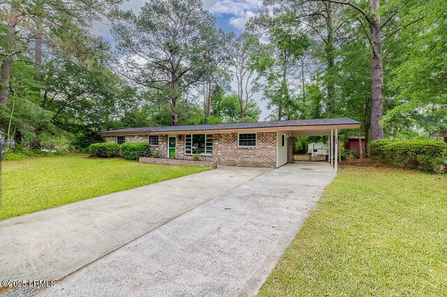 12408 Deerfield Rd, Savannah, GA 31419 - ranch-style house with driveway, a front lawn, a carport, and brick siding