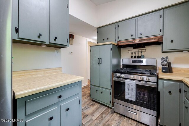 12408 Deerfield Rd, Savannah, GA 31419 - kitchen with stainless steel gas range oven, under cabinet range hood, light wood-style flooring, light countertops, and gray cabinets