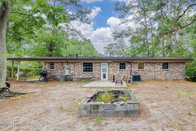 12408 Deerfield Rd, Savannah, GA 31419 - rear view of house with cooling unit, a patio area, and brick siding