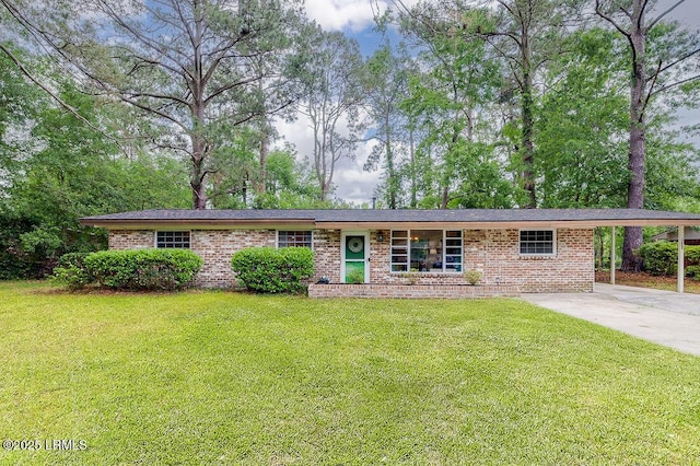single story home with brick siding, a front lawn, an attached carport, and concrete driveway
