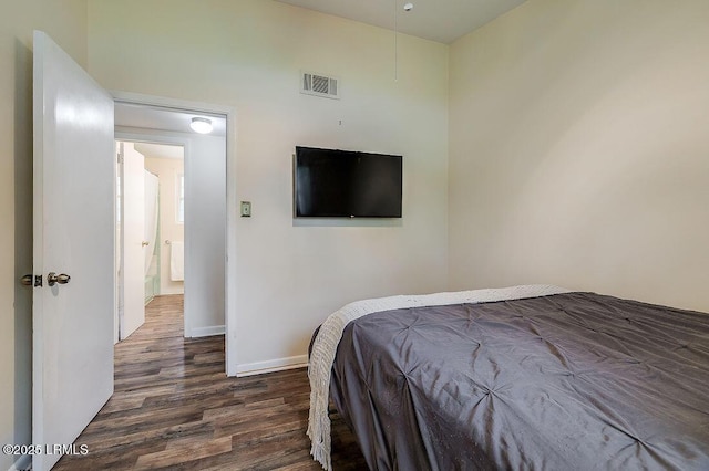 bedroom with dark wood-style flooring and baseboards