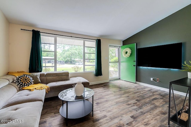 living area featuring vaulted ceiling, wood finished floors, and baseboards