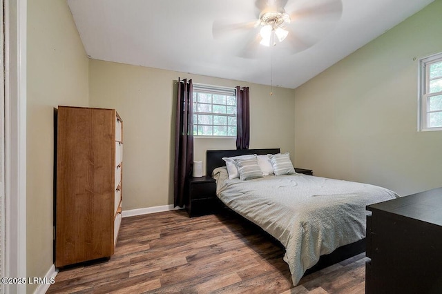 bedroom featuring vaulted ceiling, wood finished floors, baseboards, and ceiling fan