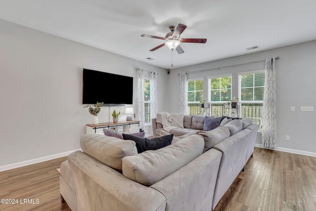 living room featuring hardwood / wood-style floors and ceiling fan