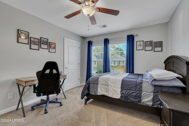 carpeted bedroom featuring ceiling fan and a closet