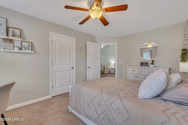 bedroom featuring light colored carpet and ceiling fan