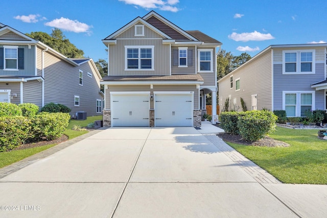 craftsman inspired home with a garage and a front yard