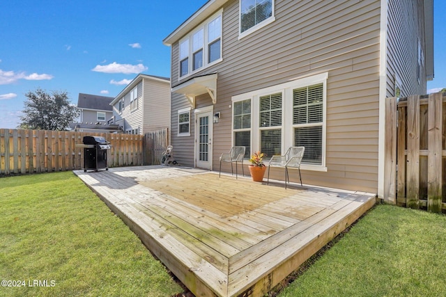 deck featuring area for grilling and a yard