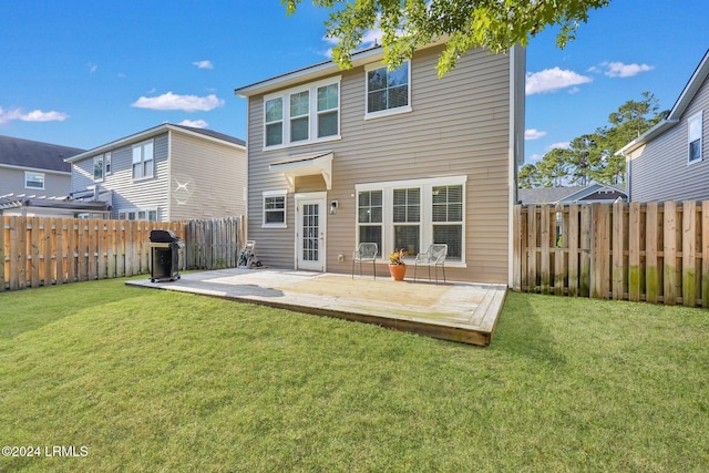 back of property with a patio and a yard