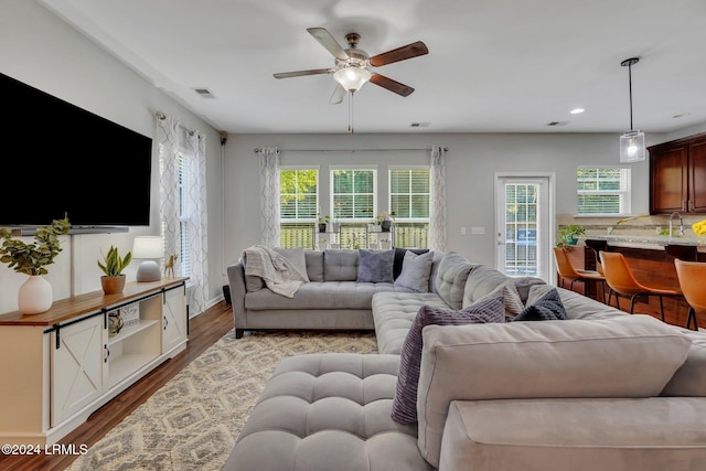 living room with ceiling fan and light hardwood / wood-style floors