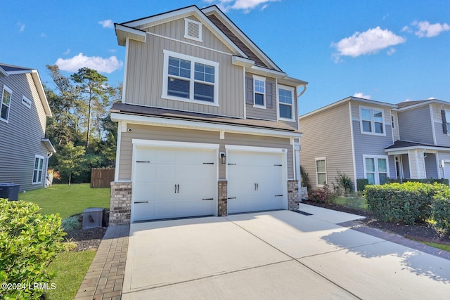 craftsman-style home featuring a garage and a front lawn