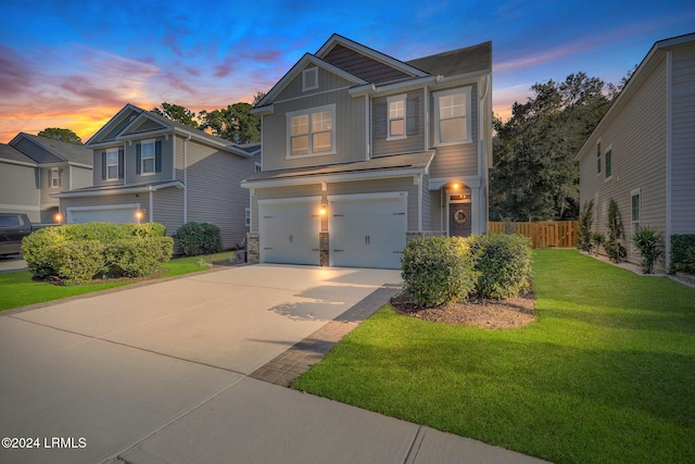 view of front of house featuring a yard and a garage