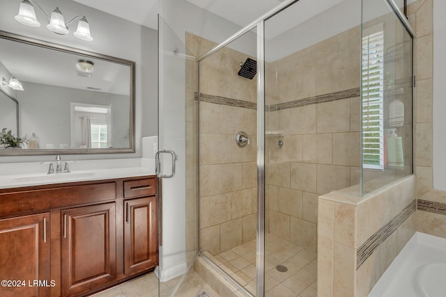 bathroom featuring vanity, tile patterned floors, and a shower with shower door