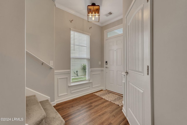 entrance foyer with crown molding and hardwood / wood-style floors