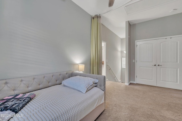 carpeted bedroom featuring ceiling fan and vaulted ceiling