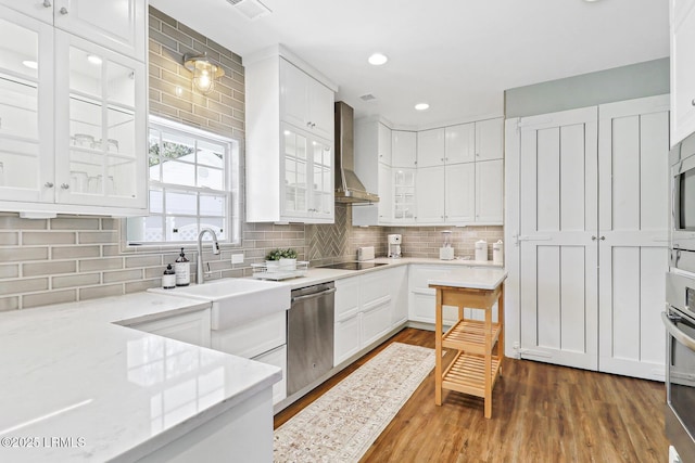 39 Barrington Ave, Bluffton, SC 29910 - kitchen featuring wall chimney range hood, white cabinets, and appliances with stainless steel finishes